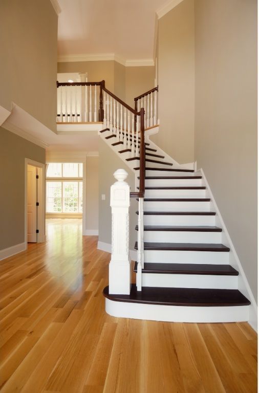 Two-toned contrasting wood staircase in Virginia Beach home recently restored