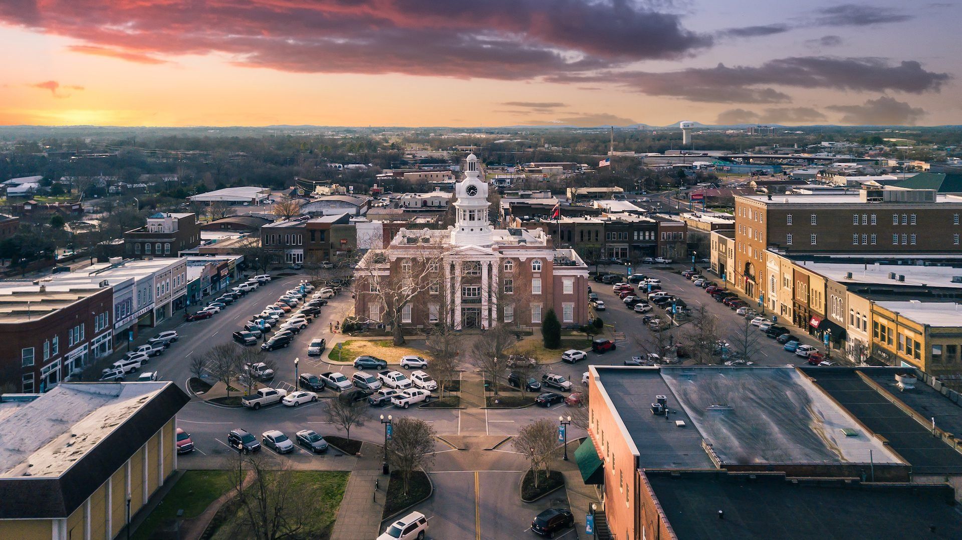An aerial view of a city with a courthouse in the middle of it.