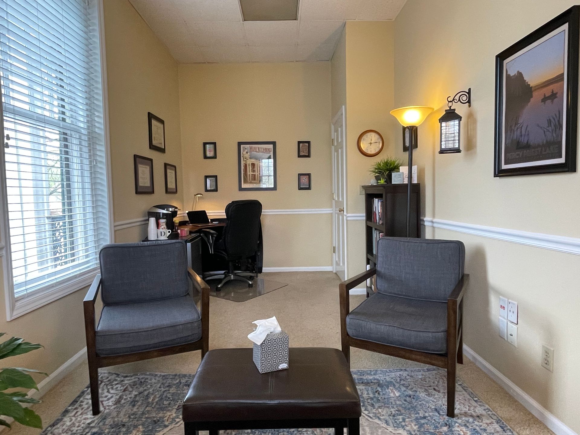 There are two chairs and a table in the room.