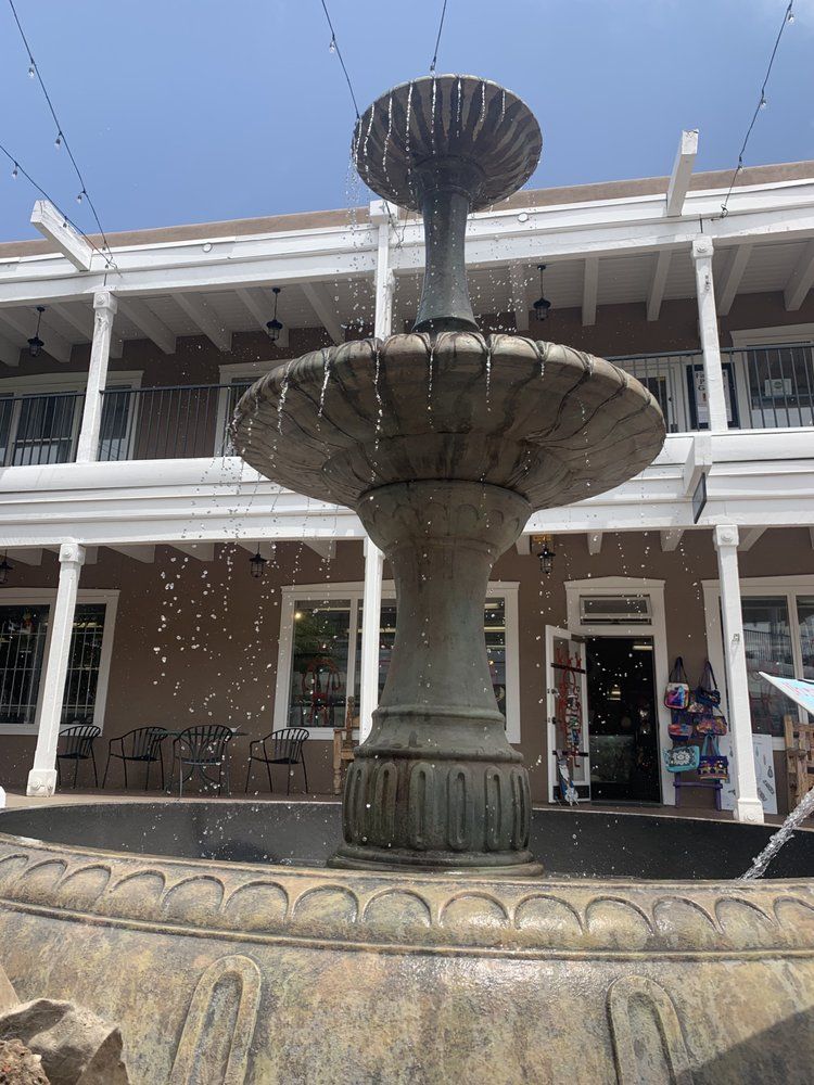 A large fountain is in front of a building