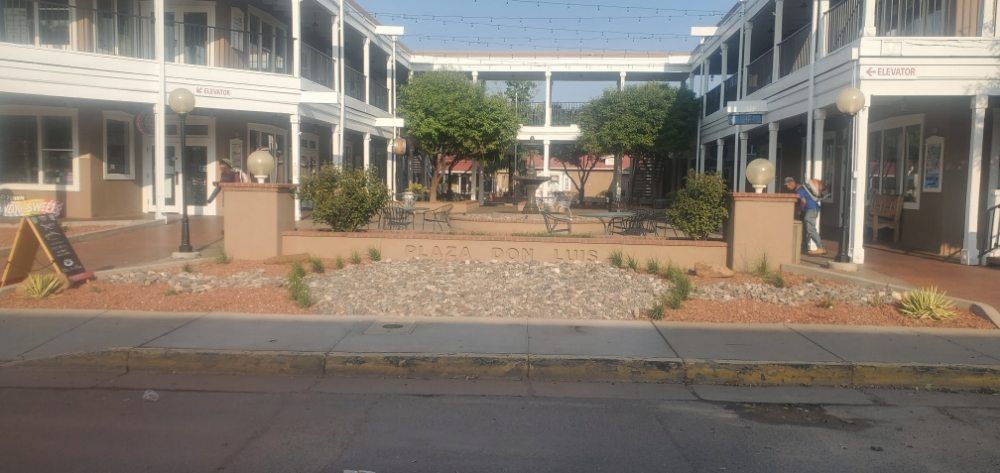 A group of buildings are sitting next to each other on a city street.