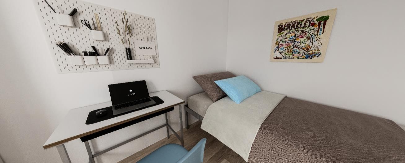 A bedroom with a bed , desk and laptop.