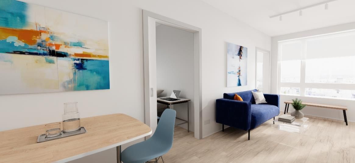 A living room with a couch , desk , chair and painting on the wall.