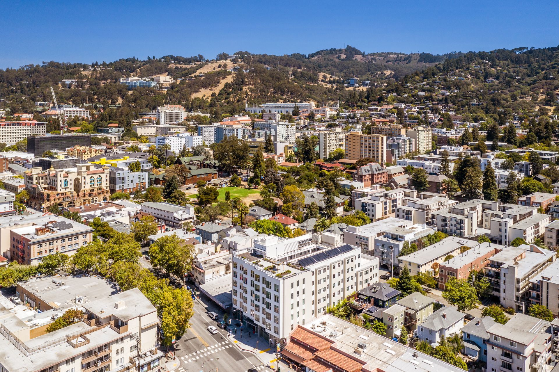 An aerial view of a city with mountains in the background.