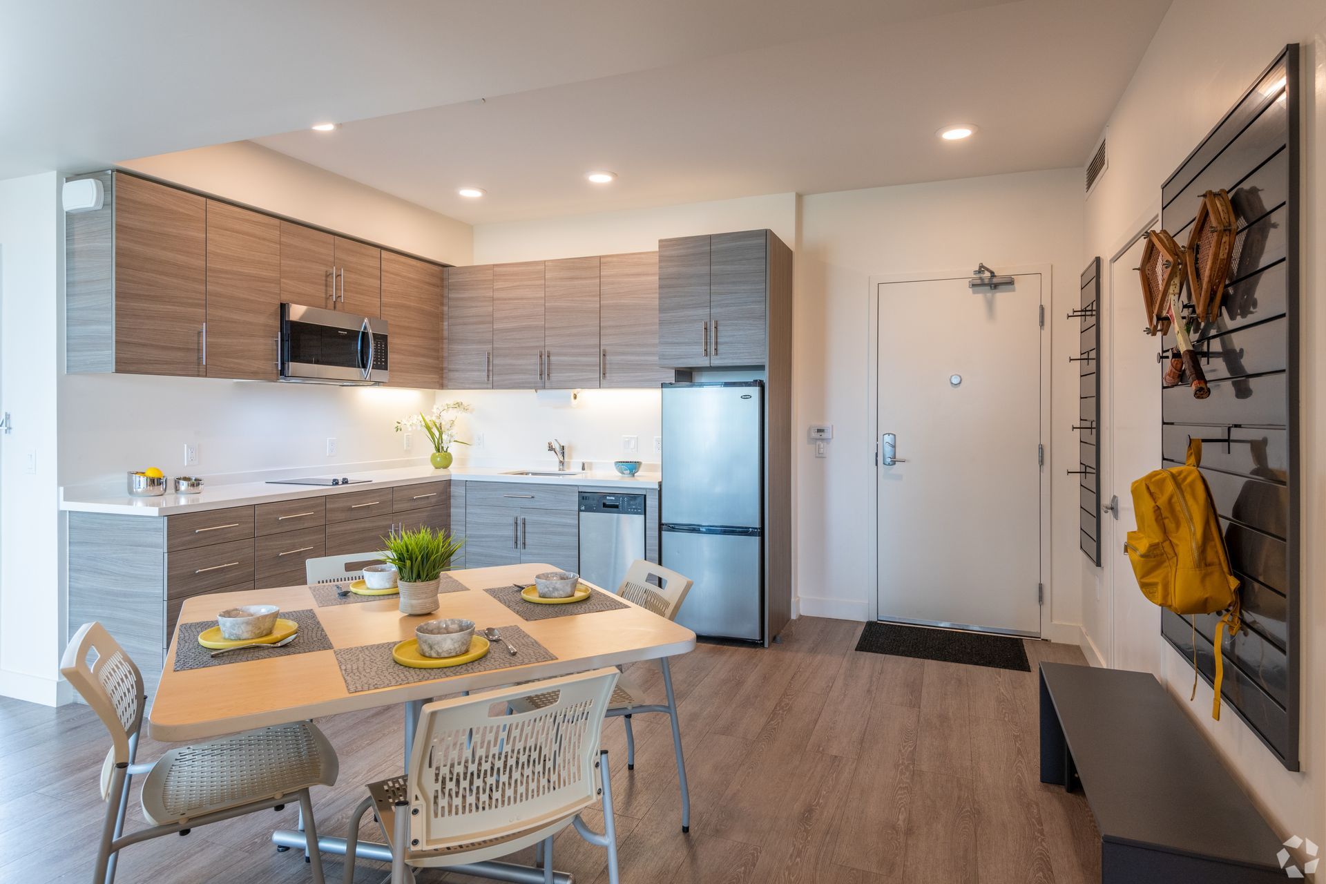 Panoramic Berkeley common area with dining table, kitchen and living room