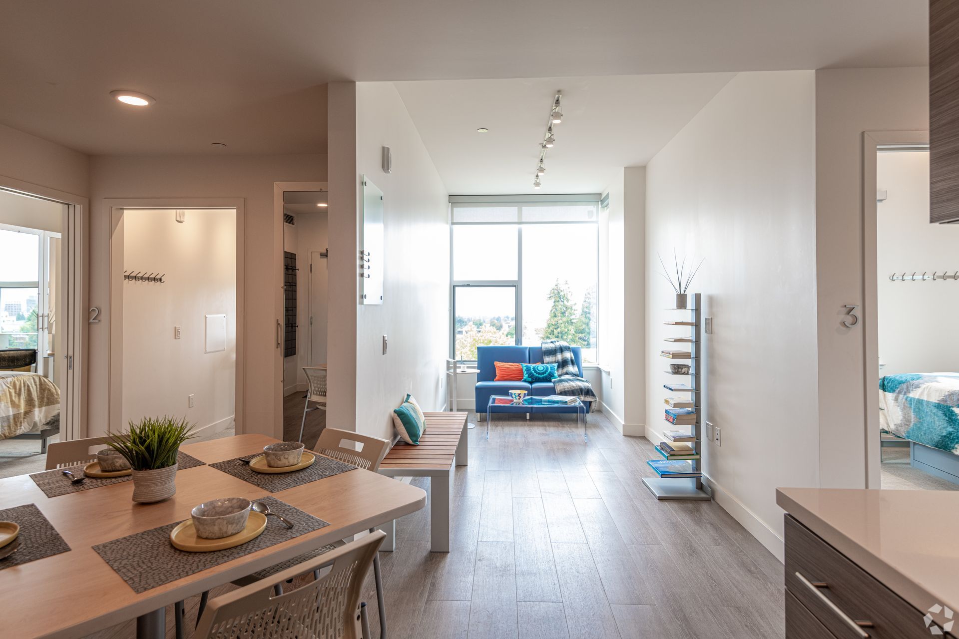 A living room with a dining table and chairs and a couch.