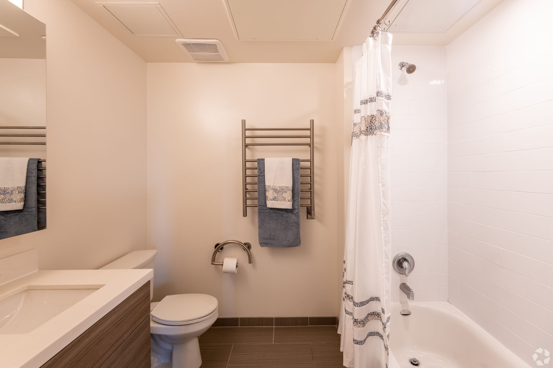 A bathroom with a toilet , sink , shower and bathtub.