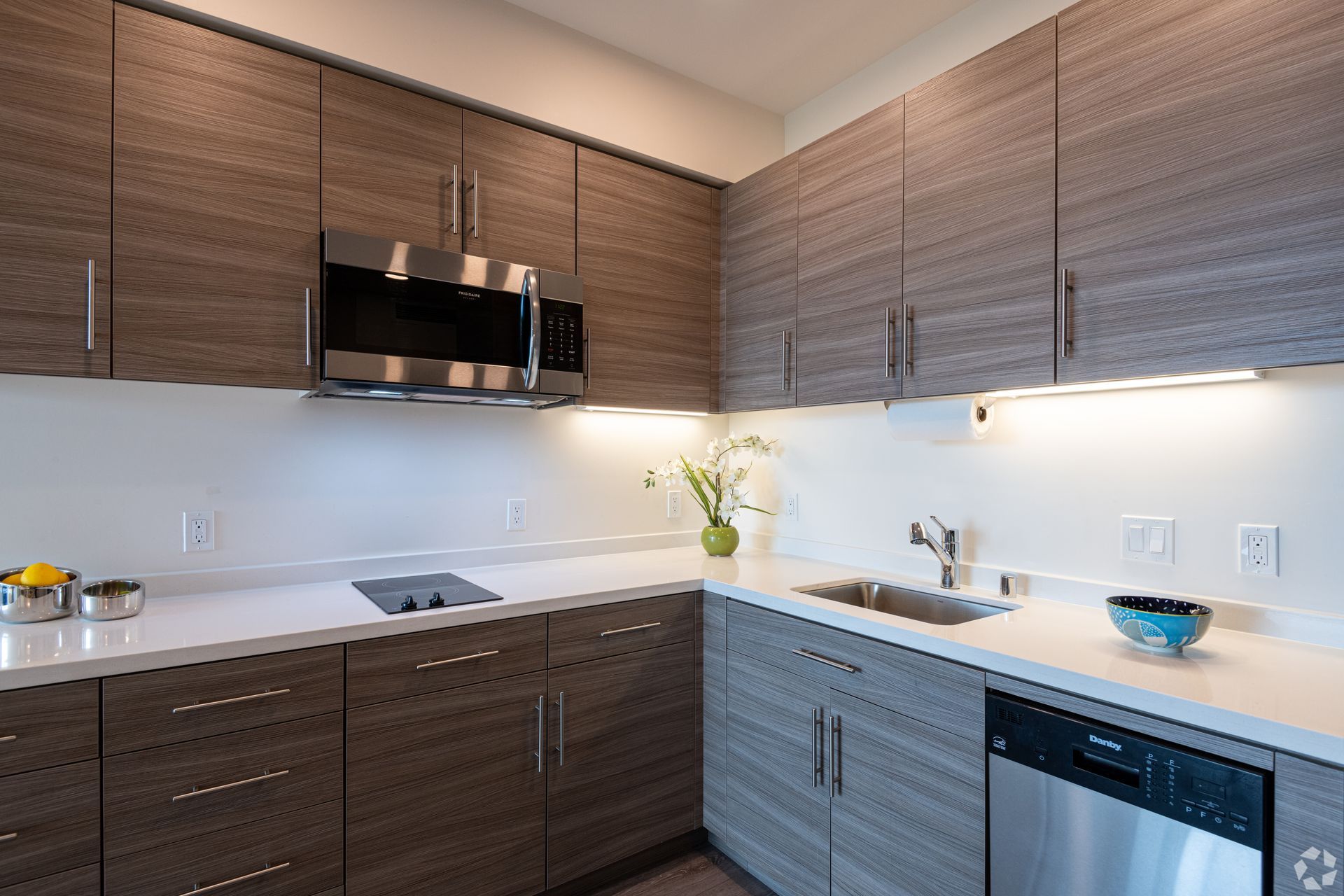 A kitchen with stainless steel appliances and wooden cabinets