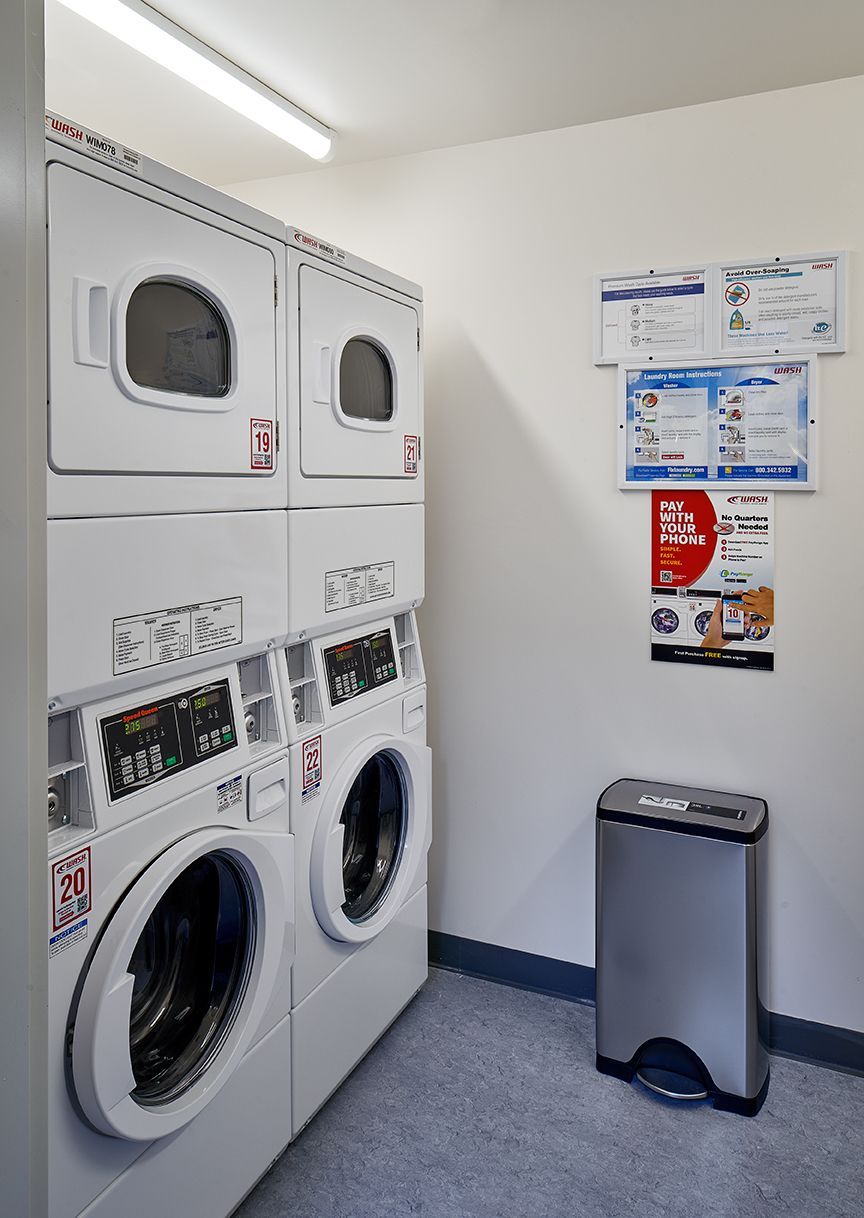 A laundromat with washers and dryers stacked on top of each other.