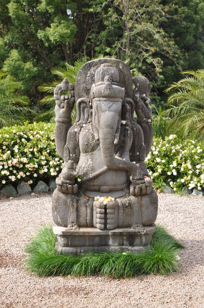 A Stone Statue of a Deity Sitting on a Rock in a Garden — Northernair in East Lismore, NSW