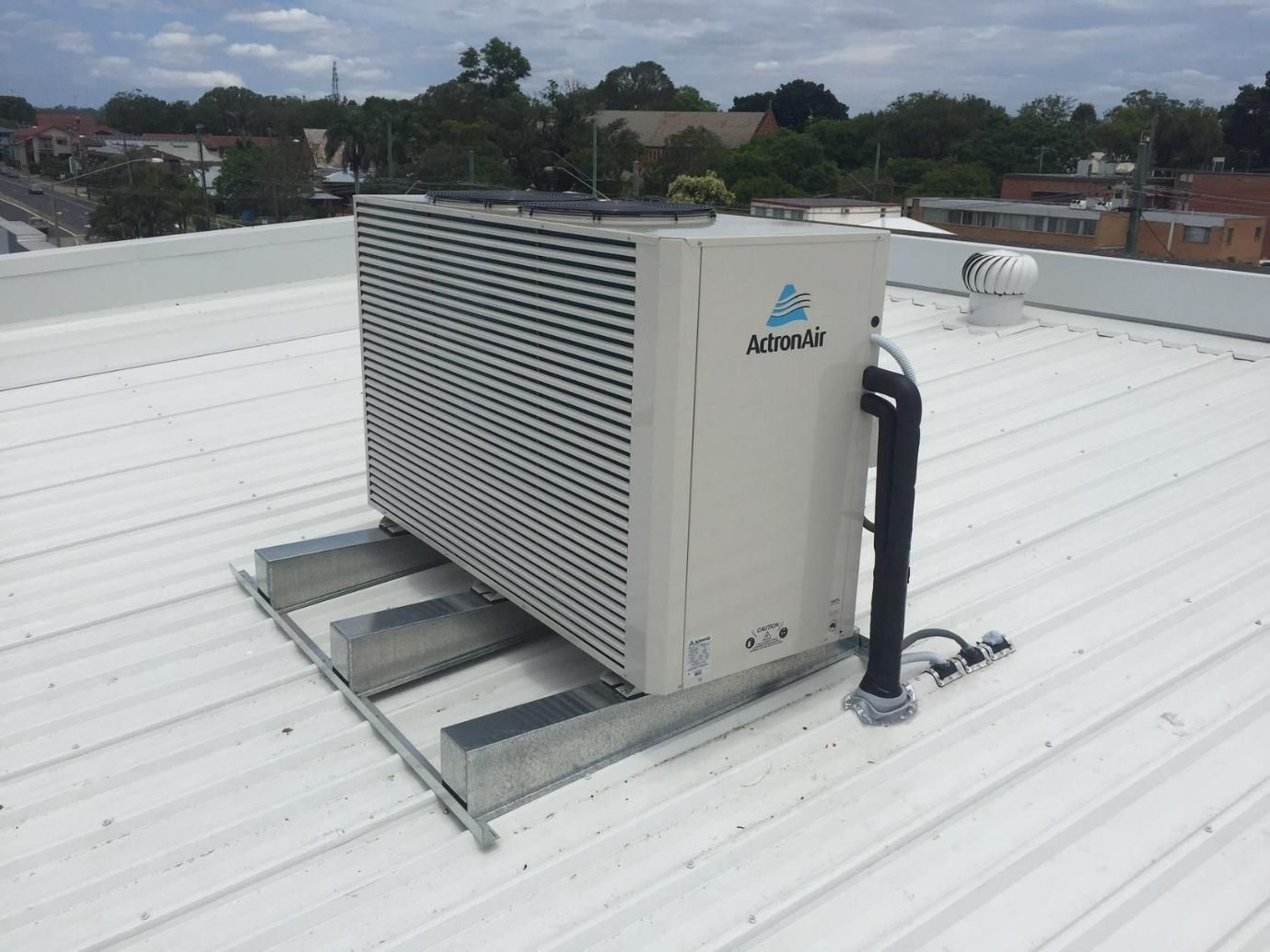 A Large Air Conditioner Is Sitting on Top of A White Roof — Northernair in East Lismore, NSW