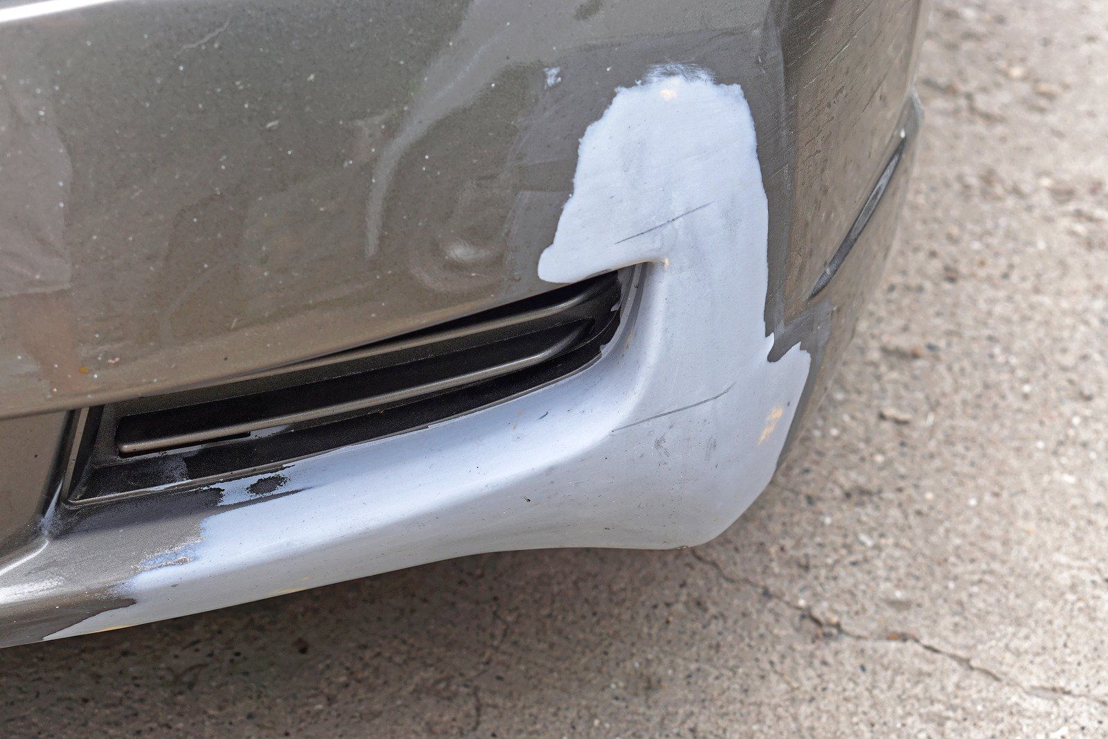 A close up of a car bumper with a scratch on it | F & M Automotive Body & Repair