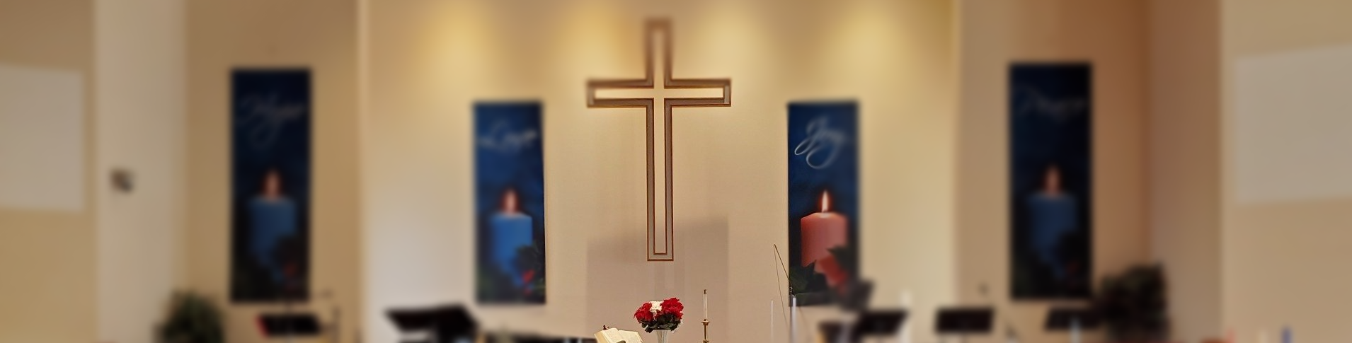 Great Room platform with cross on wall and banners showing candles.