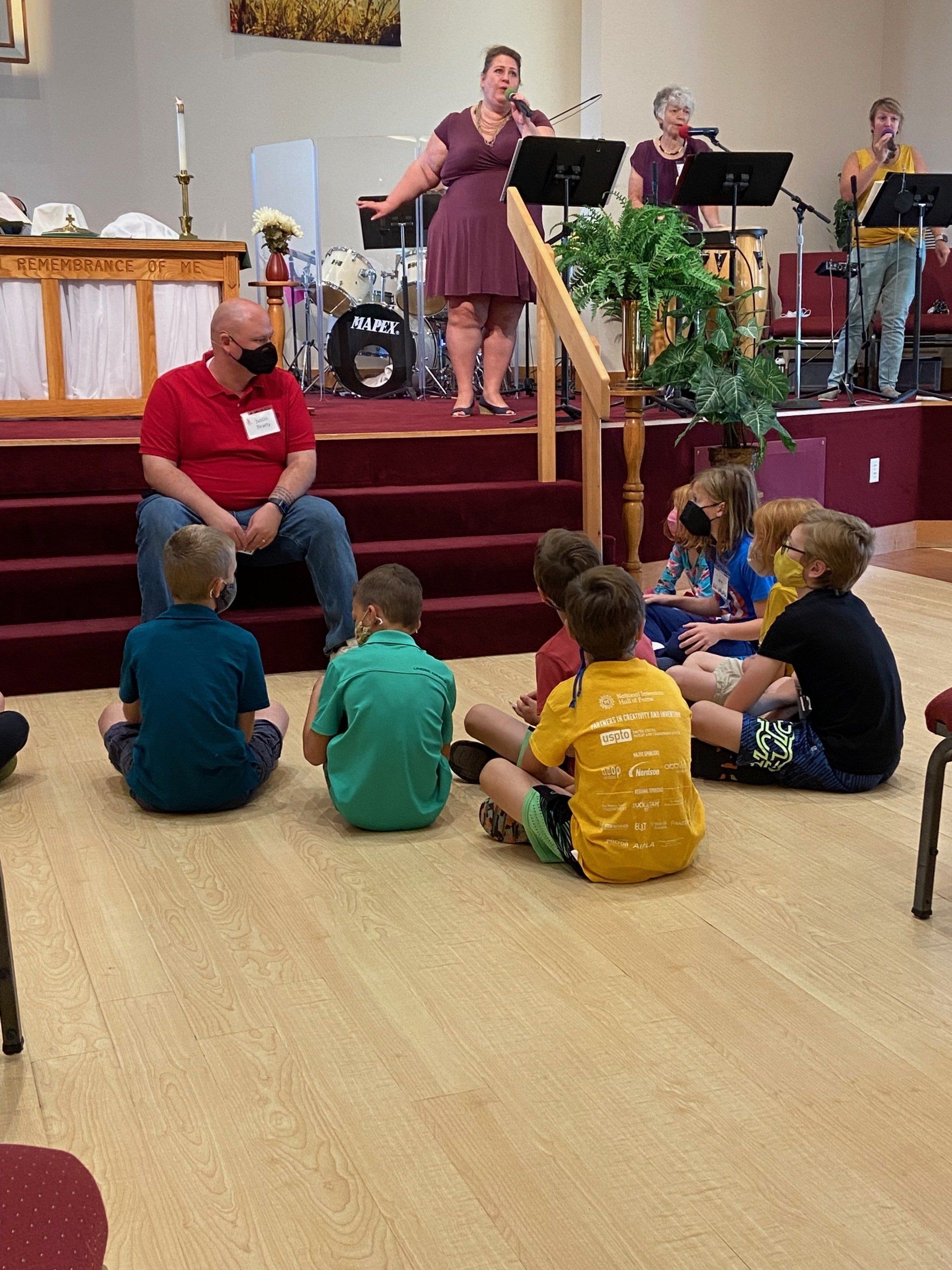 Children seated on floor for Children's Time in Worship.
