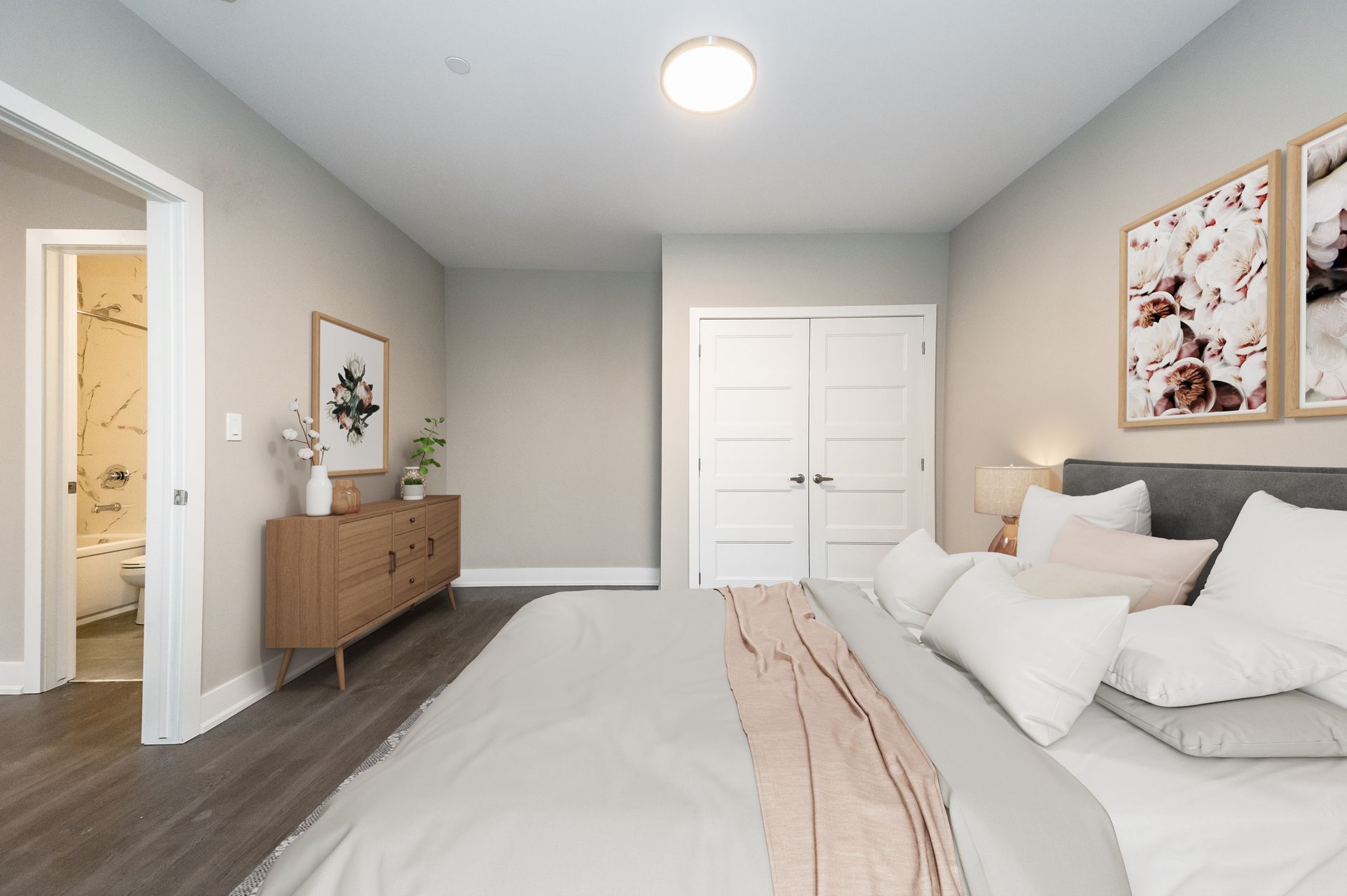 A bedroom with a large bed and a dresser.