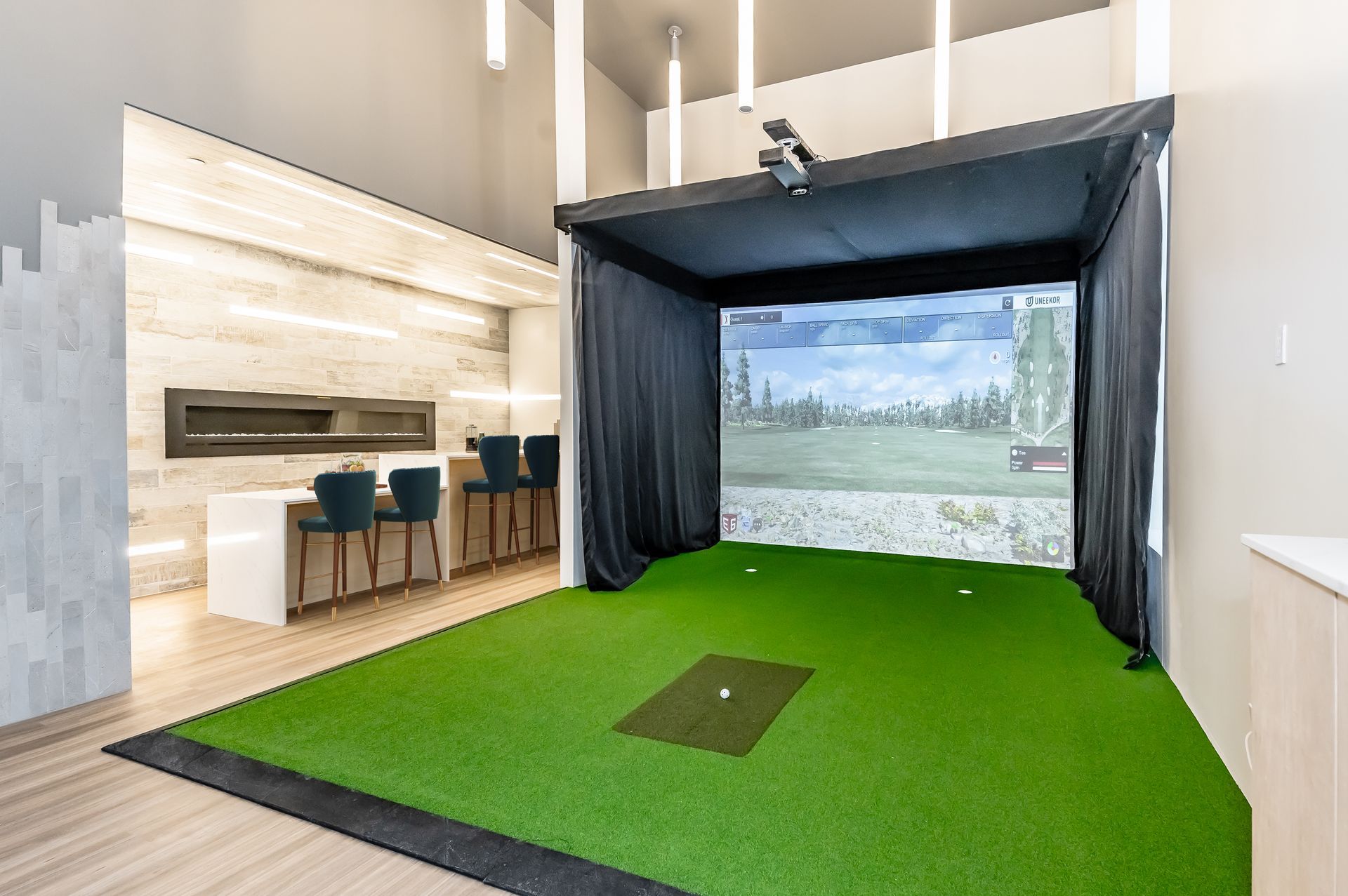 There is a golf simulator in the middle of the room.