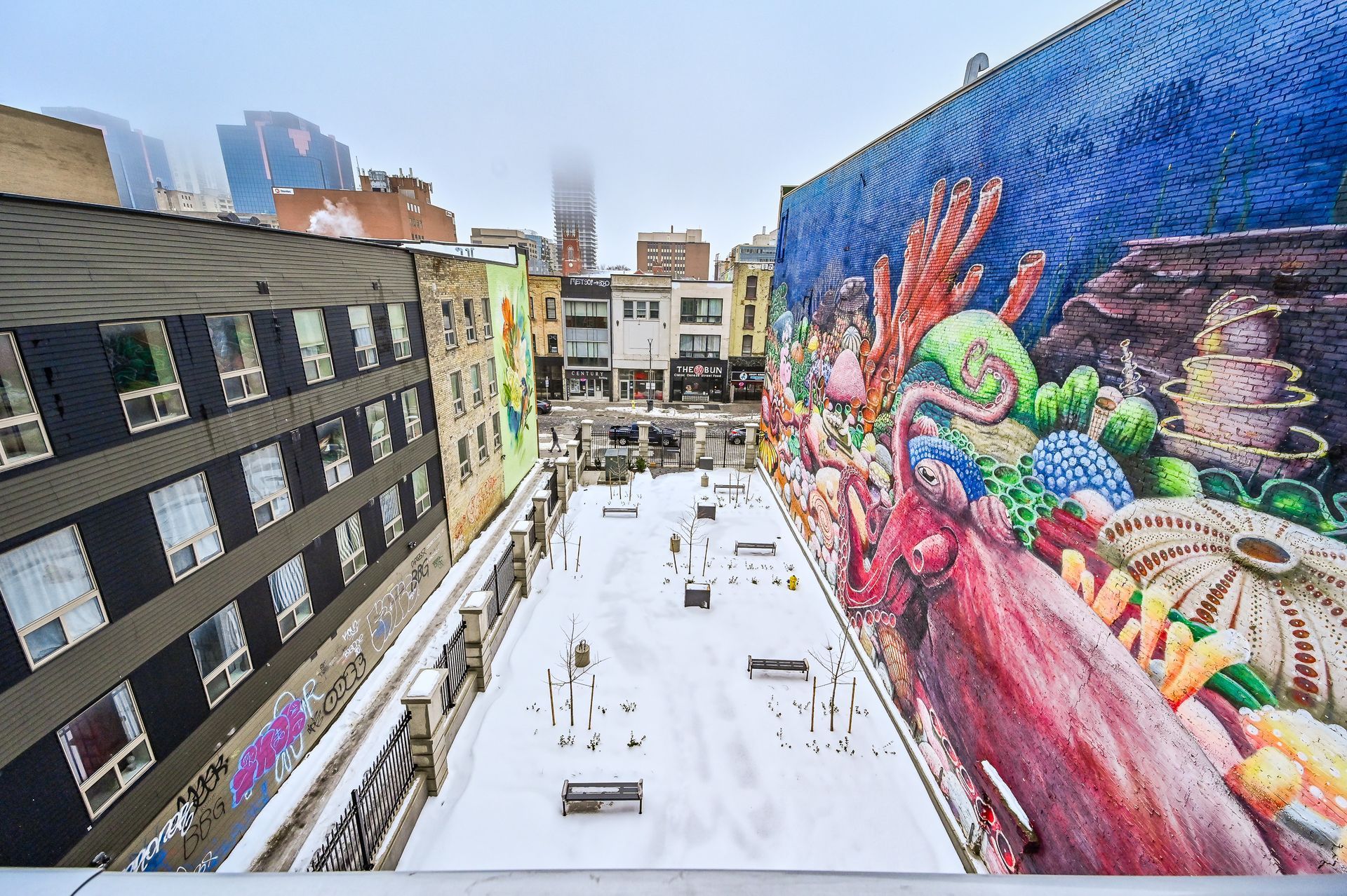 There is a large mural on the side of a building.