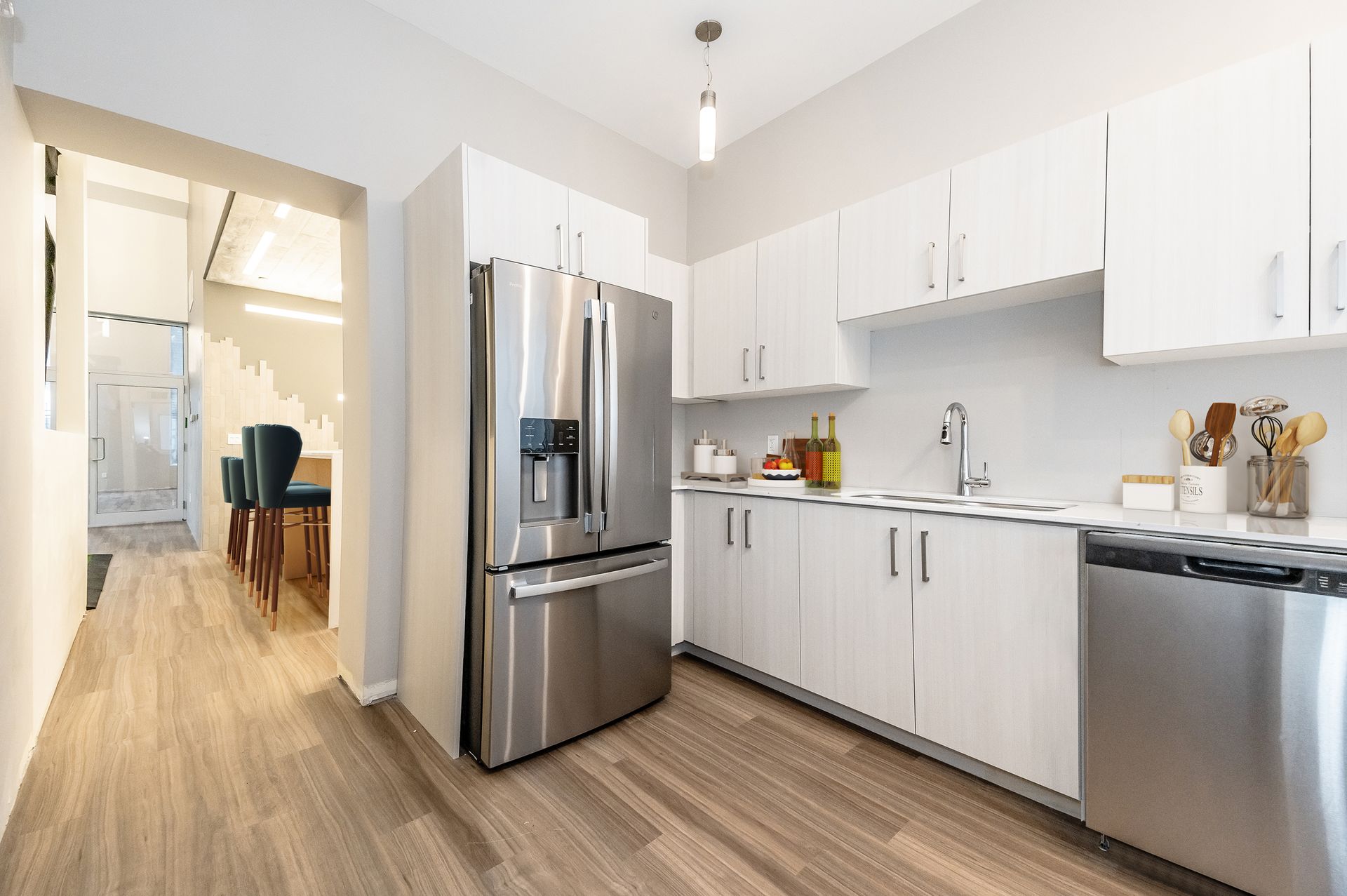 A kitchen with white cabinets and stainless steel appliances.