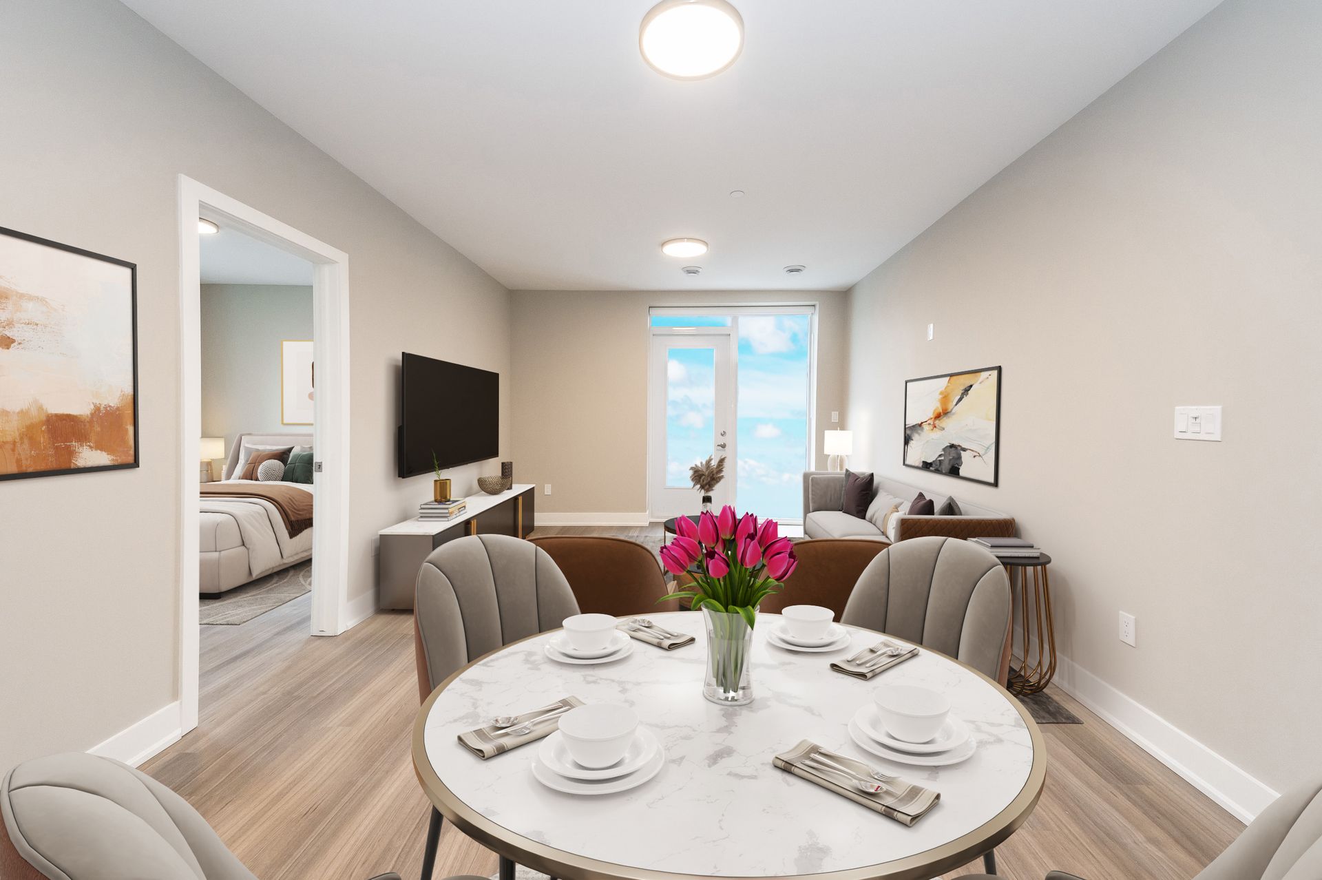 A dining room with a round table and chairs and a vase of flowers.