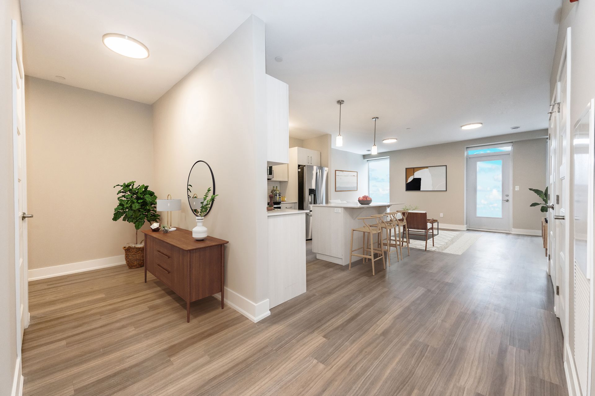 A living room with hardwood floors and a dresser in the middle of the room.