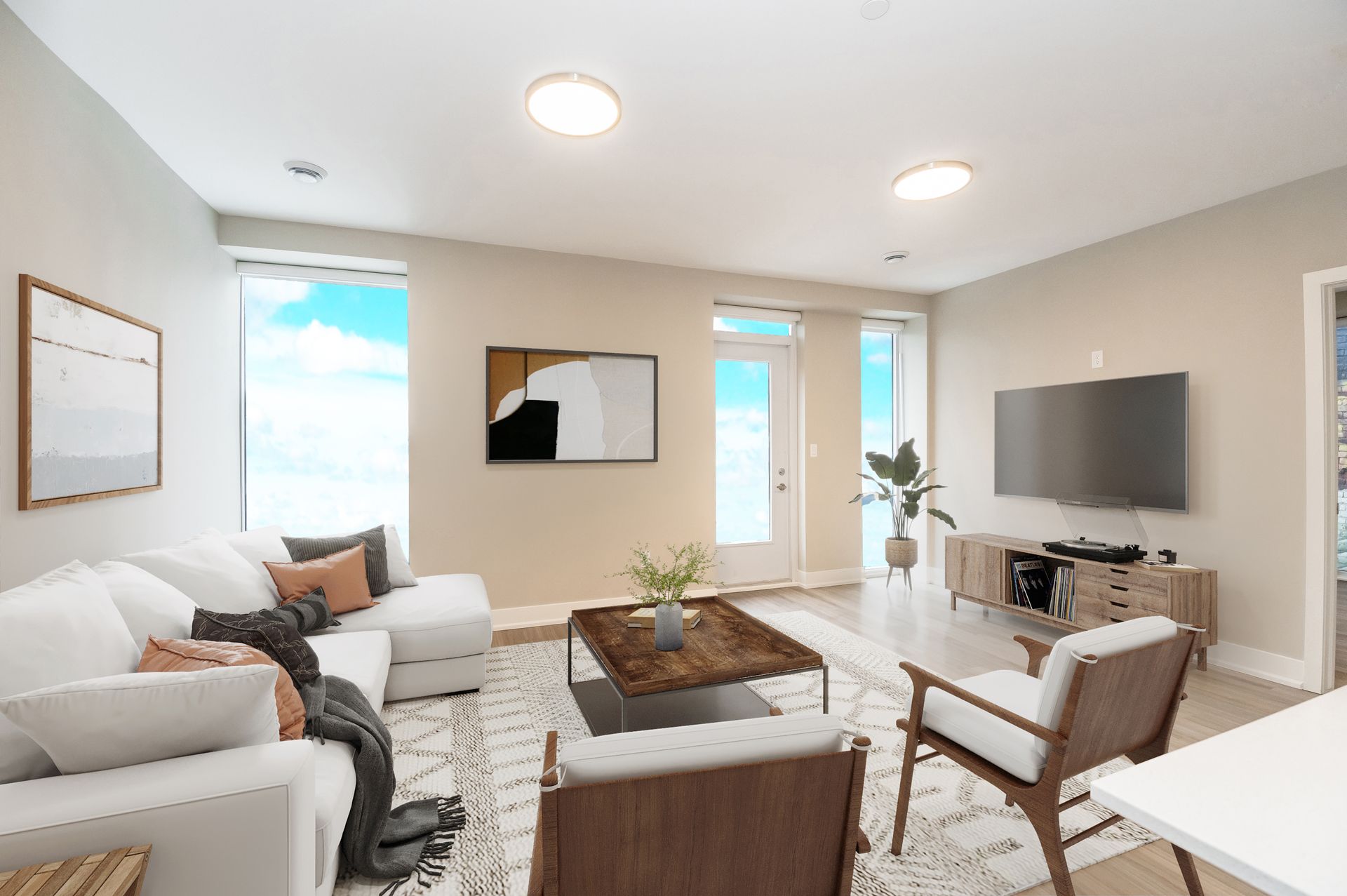 A living room with a couch , chairs , coffee table and television.