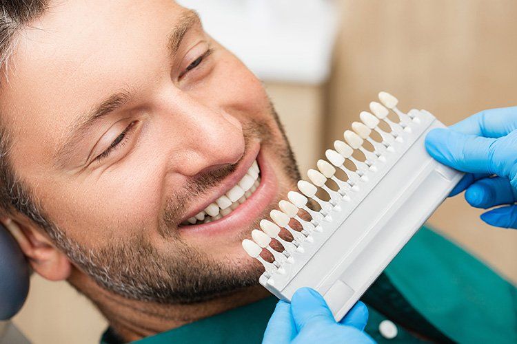 dentist comparing different types of veneer shades