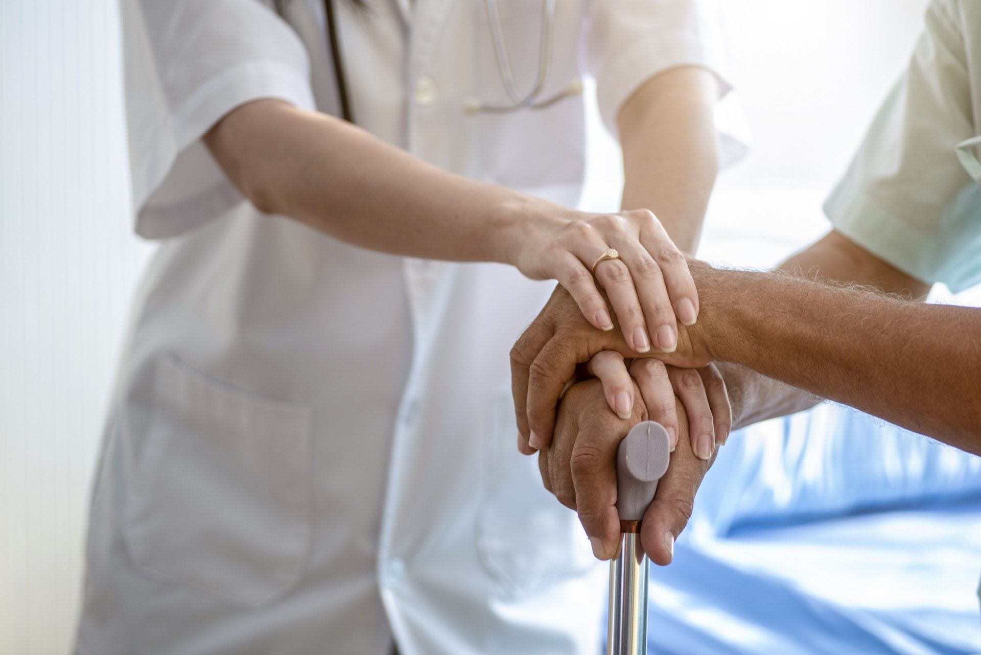 Nurse Holding Hand Of Senior Man — Sylacauga, AL — Craddock Health Center
