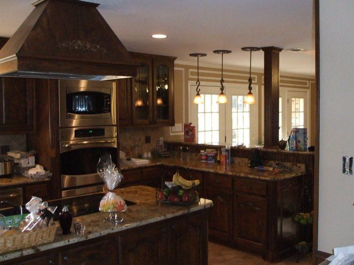 A kitchen with stainless steel appliances and wooden cabinets