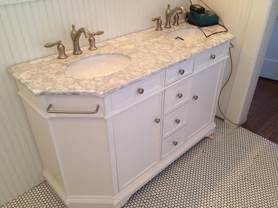 A bathroom vanity with a sink and faucets