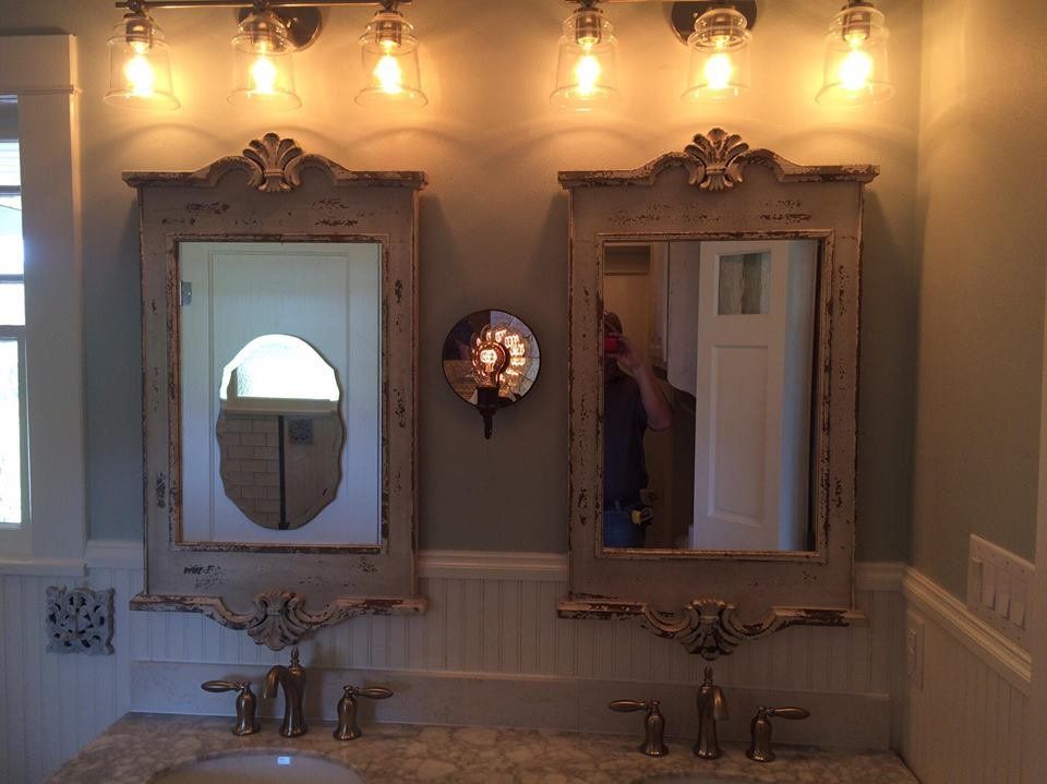 A bathroom with two sinks and two mirrors