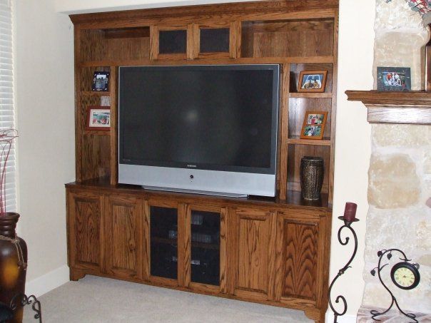A wooden entertainment center with a flat screen tv