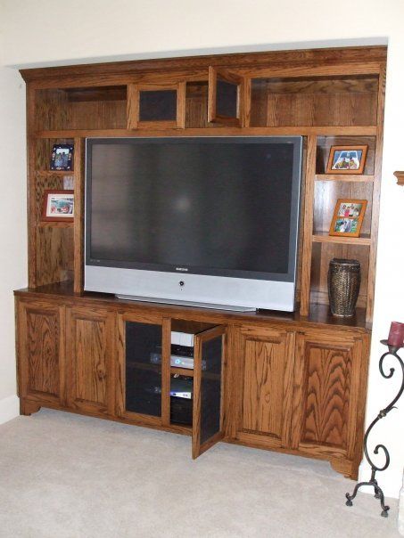 A wooden entertainment center with a flat screen tv