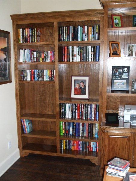 A bookshelf with a picture of a man and woman on it