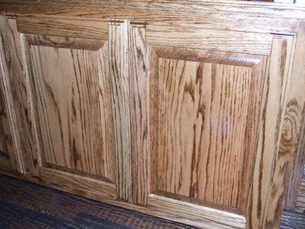 A close up of a wooden cabinet with two doors