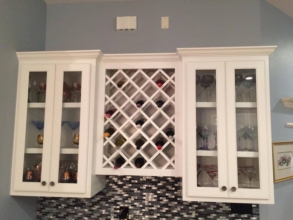 A wine rack in a kitchen with glass doors