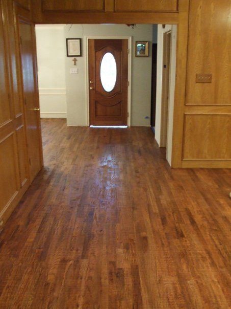 A hallway with a wooden floor and a door