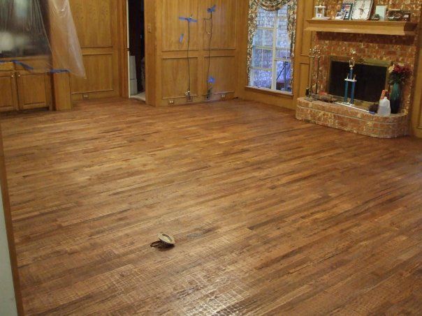 A living room with hardwood floors and a fireplace.