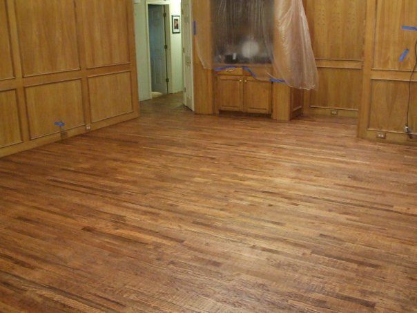 A room with a wooden floor and wooden walls.
