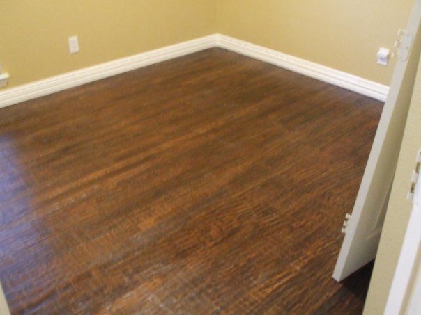 A room with a wooden floor and tan walls