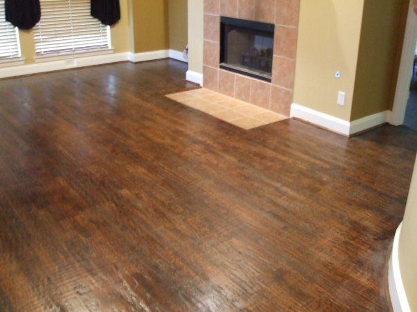 A living room with hardwood floors and a fireplace.