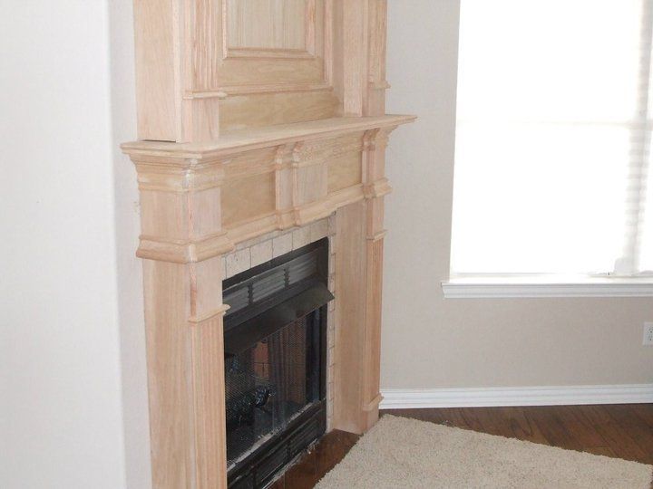 A living room with a fireplace and a window