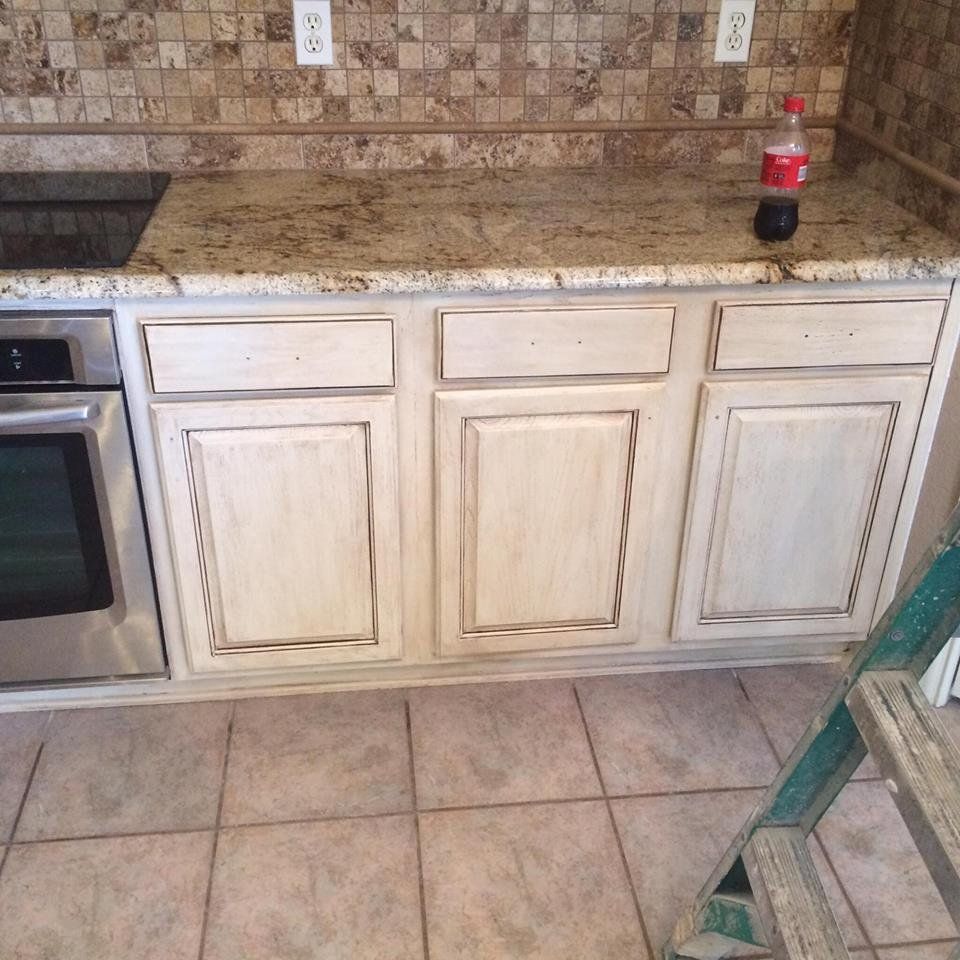 A kitchen with white cabinets and granite counter tops