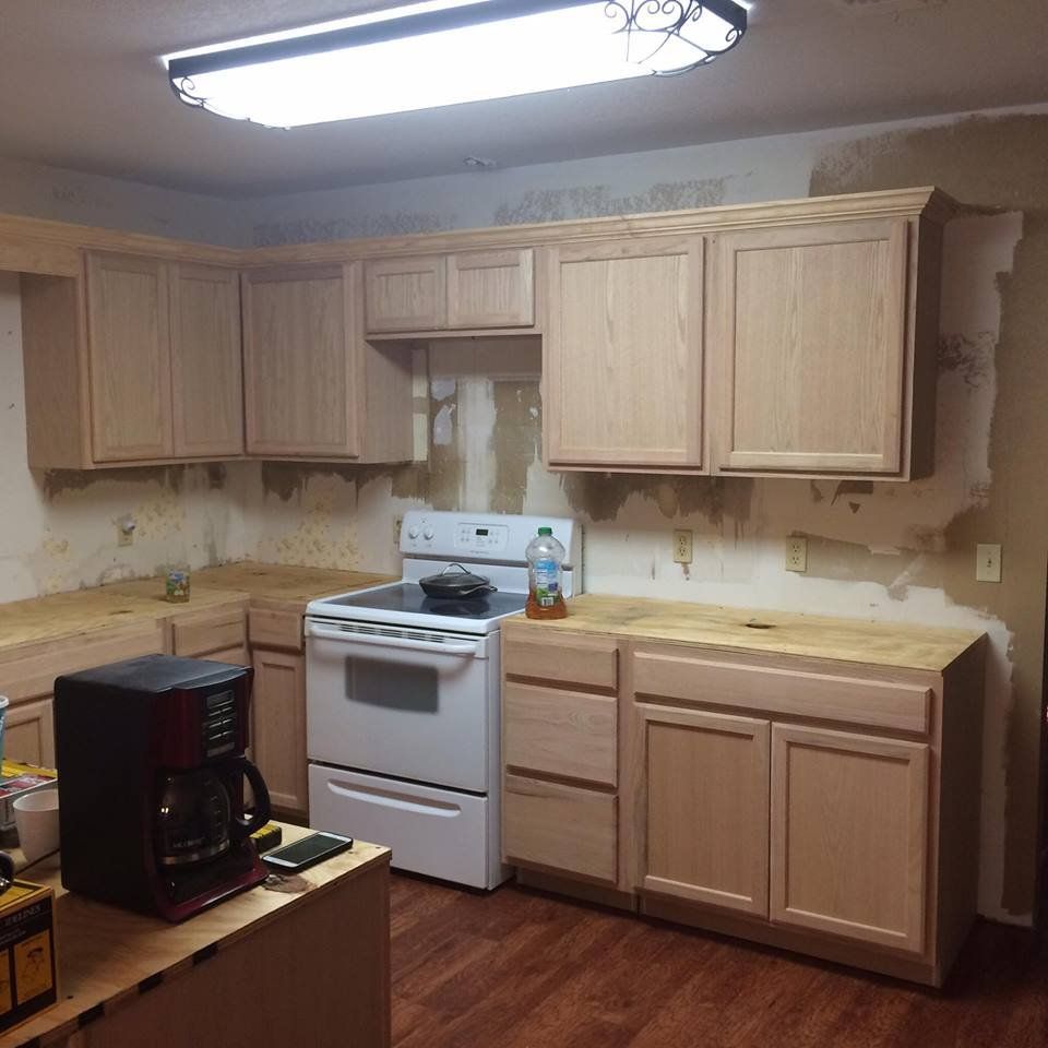 A kitchen with wooden cabinets a stove and a coffee maker