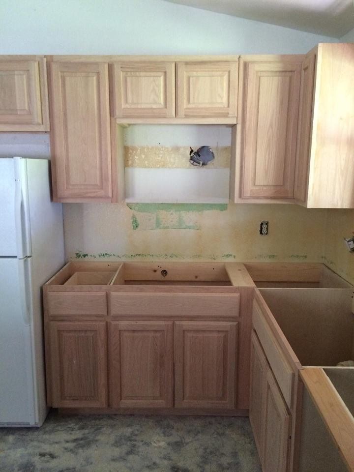 A kitchen with wooden cabinets and a white refrigerator