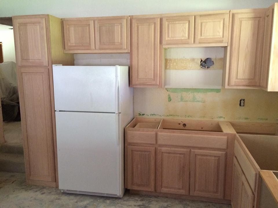 A kitchen with wooden cabinets and a white refrigerator