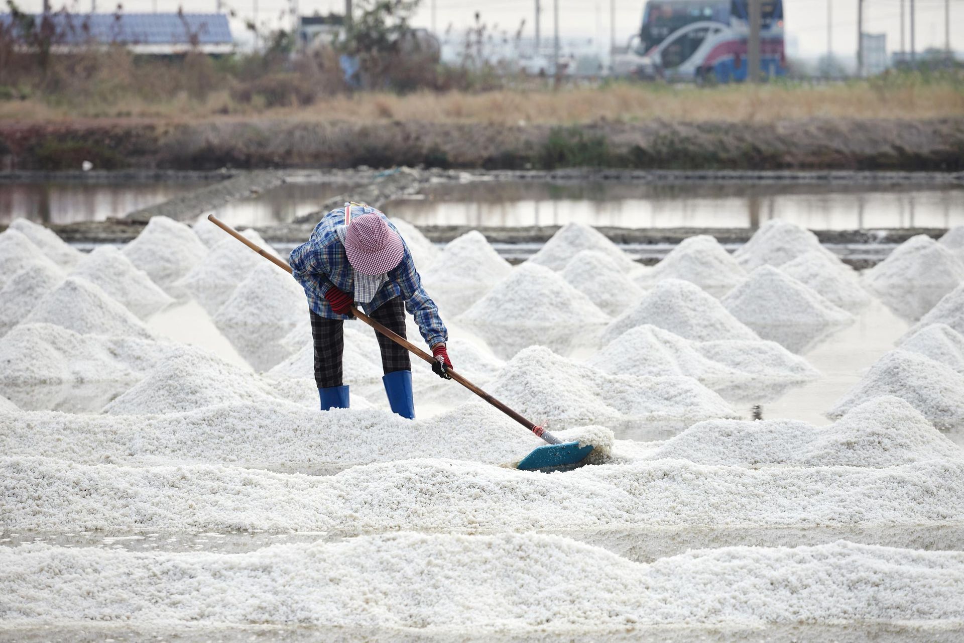 A woman sweeping salt in Waukesha, WI, symbolizes AAT Salt & Distribution. Explore Rock Salt in Wisc