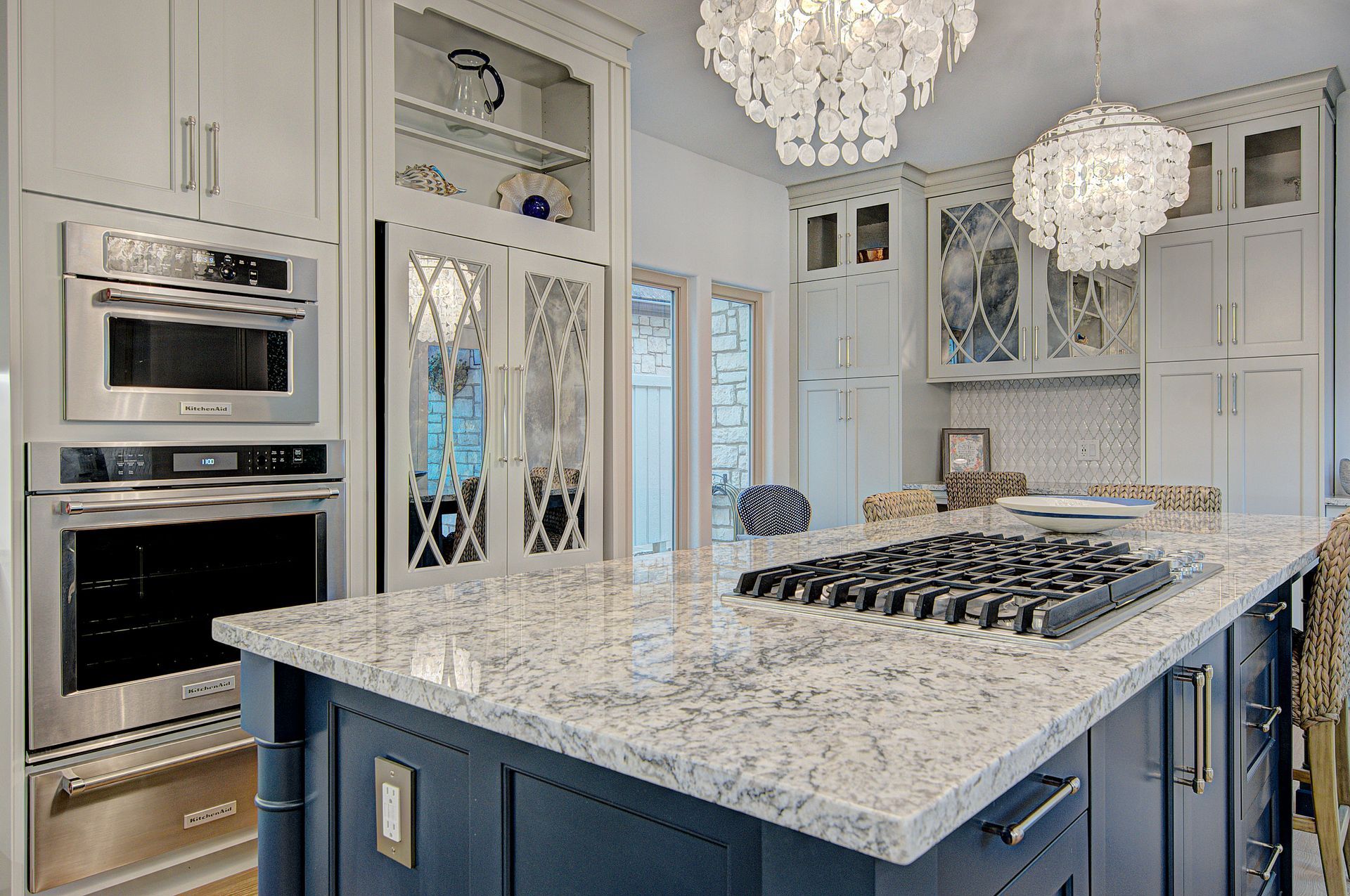 A kitchen with a large island and a stove top oven.