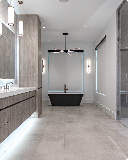 A bathroom with a black tub and two sinks