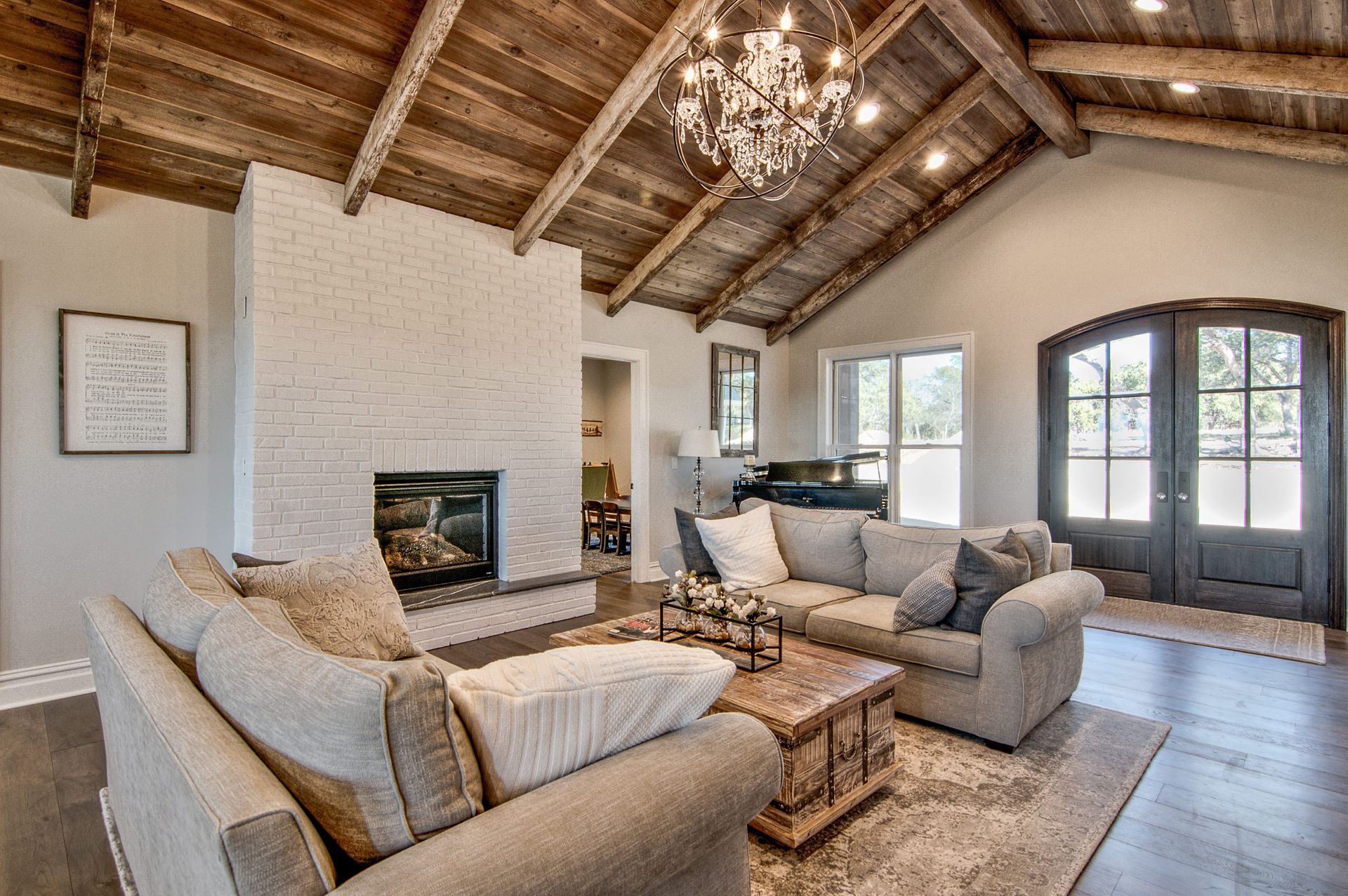 A living room with a couch , chair , coffee table and fireplace.