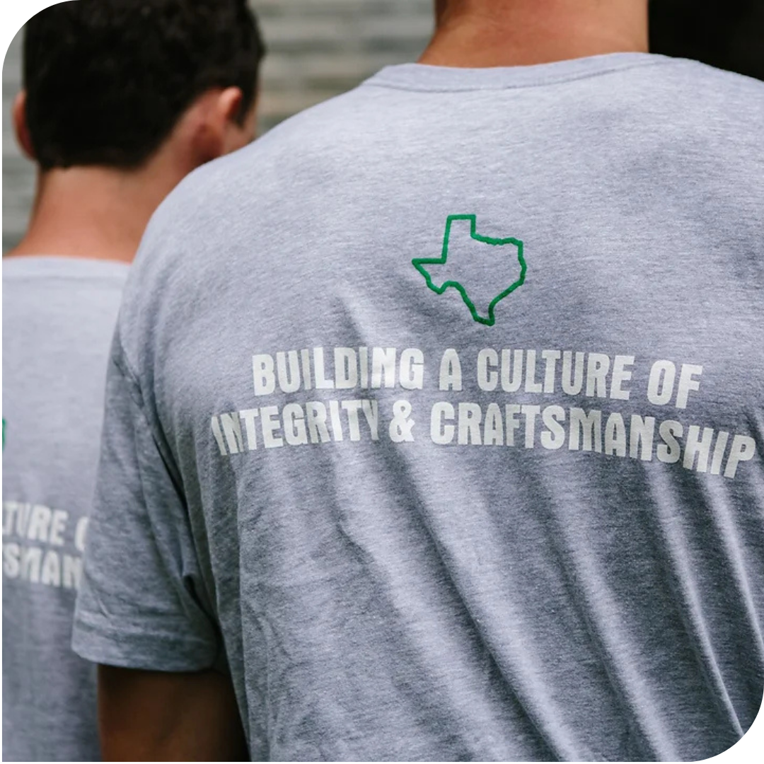 A man wearing a shirt that says building a culture of integrity and craftsmanship